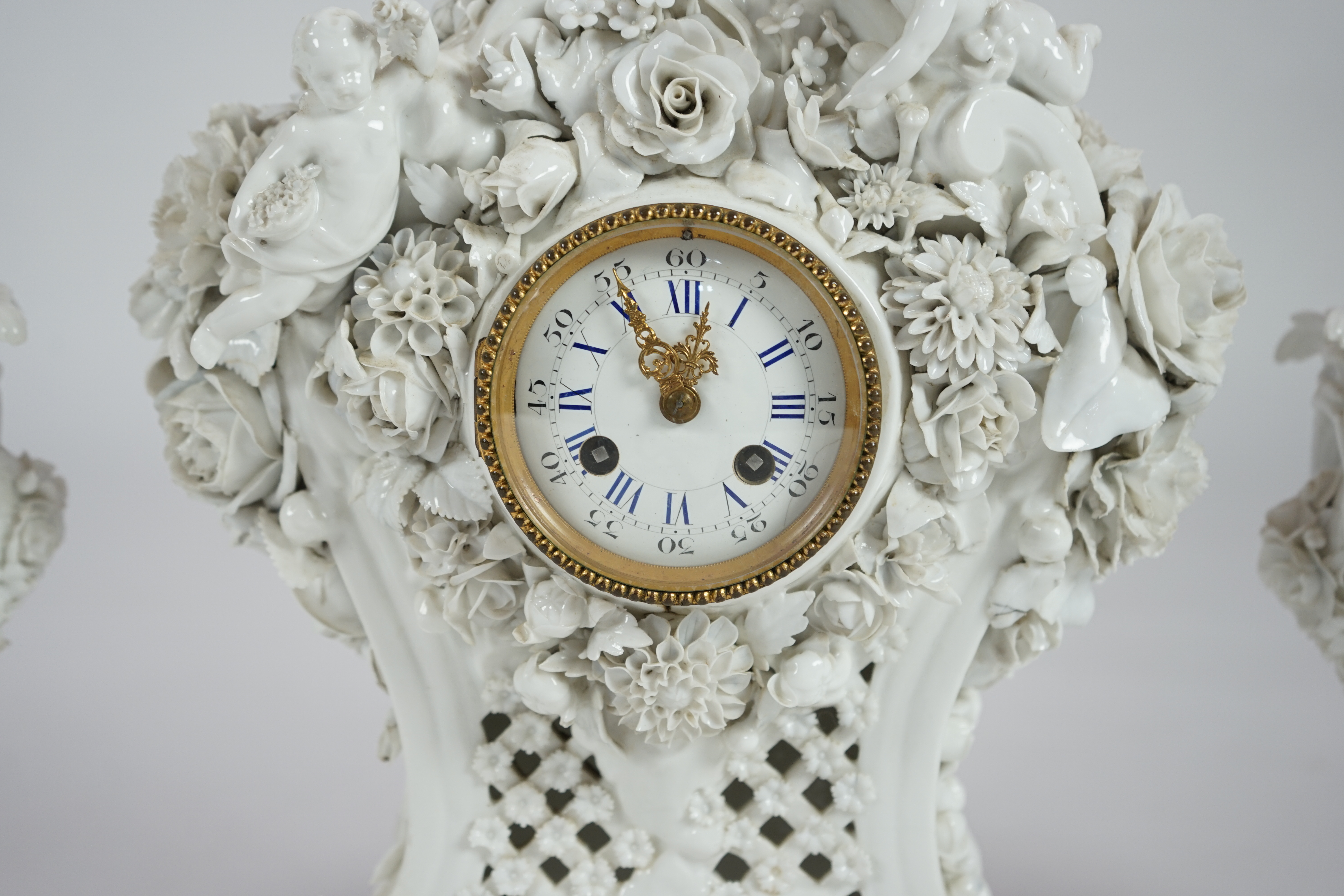 Vion & Baury. A 19th century Meissen style white glazed porcelain three piece clock set